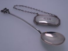 GIN LABEL & SPOON, oblong with canted corners, the gin label Sheffield 1917, 0.3ozs and a silver