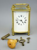 FRENCH BRASS CARRIAGE CLOCK with winding key and others having Roman numerals set to a white