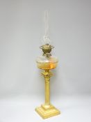 VICTORIAN OIL LAMP with clear glass facet cut font on a Corinthian column brass base, 79cms