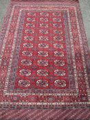 PERSIAN TYPE WOOLLEN RUG, red ground with a block pattern repeat centre and multi-bordered edge, 195