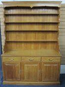 REPRODUCTION LIGHT OAK DRESSER having a four shelf rack with shaped sides on a base of three
