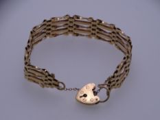 A 9CT GOLD FIVE BAR BRACELET with safety chain and padlock, 19grms
