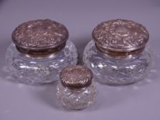 THREE SILVER TOP CUT GLASS DRESSING TABLE JARS, Birmingham hallmarks for 1902, 1963 and 1966, the