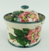 LLANELLY POTTERY PRESERVE POT & COVER painted with briar roses, of circular form with everted rim
