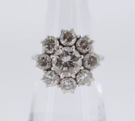WHITE METAL NINE-STONE DIAMOND CLUSTER RING, the central stone (1.0ct approx.) surrounded by eight