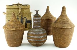 THREE AFRICAN BASKETS WITH CONICAL COVERS, possibly Tutsi, tallest 44cms, an Ethiopian wired