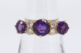 18CT GOLD SEVEN-STONE AMETHYST & DIAMOND RING, the three amethysts separated by four small