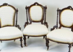 THREE LATE VICTORIAN WALNUT NURSING CHAIRS, similarly upholstered on turned fluted legs with ceramic