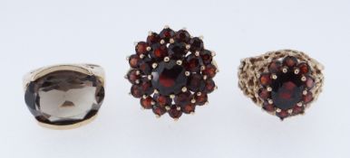 TWO 9CT YELLOW GOLD GARNET SET DRESS RINGS TOGETHER WITH 9ct gold smoky quartz ring, 15.1gms (3)