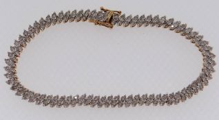 9CT GOLD LADIES BRACELET SET WITH A TWIN ROW OF DIAMOND CHIPS, 19.5cms long, 10.1gms