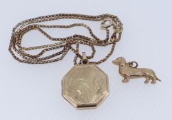 9CT YELLOW GOLD OCTAGONAL LOCKET ON 9CT GOLD CHAIN, together with 9ct gold dachshund charm, 7.2gms
