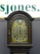 BRASS DIAL CARVED OAK LONGCASE the arched dial top marked 'Tempus Fugit', flanked by dolphin pierced
