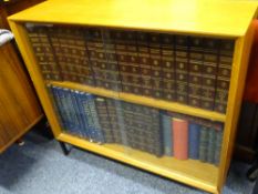 TEAK BOOKCASE containing 25 volume set of The Encyclopaedia Britannica and other books and bound