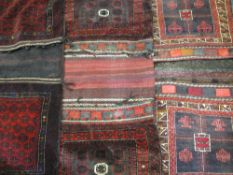 THREE MIDDLE EAST/PERSIAN TYPE CAMEL BAGS, red ground mainly with traditional block patterns and