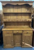 REPRODUCTION PINE INVERTED BREAKFRONT DRESSER having a two shelf rack with central spice drawers