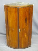 GEORGIAN MAHOGANY BOW FRONT HANGING WALL CUPBOARD with star inlay to the doors, the interior with