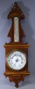 ANEROID BAROMETER IN CARVED OAK FRAME