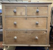 VICTORIAN STRIPPED PINE CHEST of two short over two long drawers with turned wooden knobs and bun