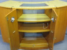 MID-CENTURY TEAK COCKTAIL CABINET/FOLD-OUT BAR by Turnidge of London, having a fold-out top in