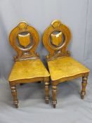 VICTORIAN OAK HALL CHAIRS, A PAIR, the circular backs with carved detail, central pierced shield