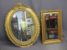TWO GILT FRAMED WALL MIRRORS to include a pine and gesso moulded oval example with leaf and floral