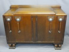 ART DECO OAK SIDEBOARD with railback and stepped top over an arrangement of four cupboard doors,