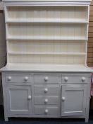 LATE VICTORIAN PAINTED PINE DRESSER having a three shelf rack over a T arrangement of three frieze