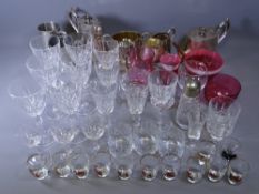 GLASSWARE - a quantity of drinking glasses, Cranberry glassware ETC, also a four piece silver