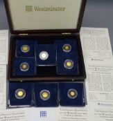 EIGHT WESTMINSTER 'SMALLEST GOLD COINS OF THE WORLD COLLECTION' in a mahogany effect case with