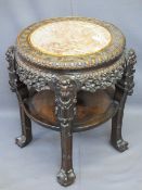 CHINESE CARVED HARDWOOD CIRCULAR STAND with pink marble inset top and under tier shelf, 68cms H,