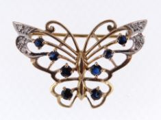 9CT GOLD BAR BROOCH of butterfly design set with eight sapphires and diamond chips, 4.8gms