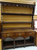 18TH CENTURY OAK WELSH DRESSER, open two-shelf Delft rack with original wrought iron hooks, on