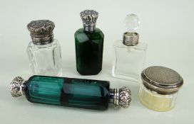 FOUR VICTORIAN SILVER MOUNTED CUT GLASS SCENT BOTTLES, comprising a green double ended bottle,