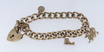 9CT GOLD CURB LINK CHARM BRACELET, c. 1972, suspending three charms: Welsh Dragon, St. Christopher