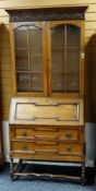 REPRODUCTION OAK BUREAU BOOKCASE in the 17th Century style, astragal glazed cabinet doors above
