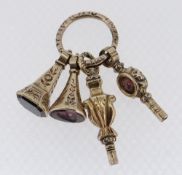 FOUR VICTORIAN LADIES GOLD PLATED FOB SEALS & WATCH KEYS, the former set with amethyst lily-of-the-