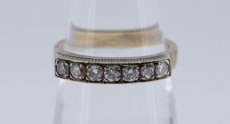 YELLOW METAL SEVEN STONE DIAMOND RING totaling 0.28cts overall approximately (visual estimate), size