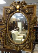 MODERN ITALIAN-STYLE GILT COMPOSITION MOULDED MIRROR, decorated with flowers, 144cms high