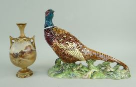 ROYAL WORCESTER PORCELAIN TWIN-HANDLED VASE shape 2440, decorated with a thatched cottage in a rural