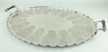EDWARDIAN ELECTROPLATED OVAL TEA TRAY, BY DANIEL & ARTER, with wavy rim and turned ebony handles,