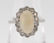 18CT WHITE GOLD OPAL & DIAMOND CLUSTER RING, the central opal (1.1 x 0.6cms) surrounded by