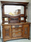 EDWARDIAN WALNUT PARLOUR CABINET with mirror glazed and carved back, above chest base of cupboards