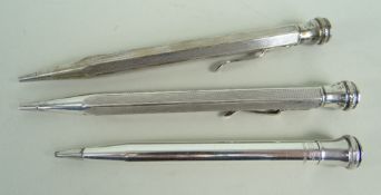 THREE SIMILAR WHITE METAL PROPELLING PENCILS comprising two stamped '900' and an Eversharp example