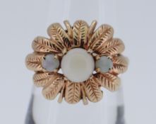 9CT GOLD THREE STONE OPAL RING of flower head design, size O / P, 5gms in box