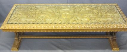 AN EASTERN HEAVILY CARVED LONG-JOHN COFFEE TABLE with a glazed top, 50cms H, 150cms W, 56cms D