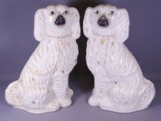 LARGE PAIR OF WHITE STAFFORDSHIRE SEATED SPANIELS, 38cms H (A/F)