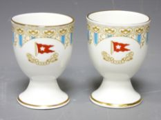WHITE STAR LINE EGG CUPS, a pair, probably reproduction R D No 334028 and 'Titanic 1912' printed