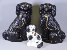 STAFFORDSHIRE JACKFIELD TYPE BLACK SEATED SPANIELS, a pair, 37cms H and one other
