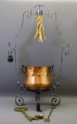 WROUGHT IRON CAULDRON STAND with copper swing-handled cauldron and a selection of brassware