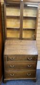 VINTAGE OAK BUREAU BOOKCASE having twin glazed doors over a pigeon hole interior and fall front with